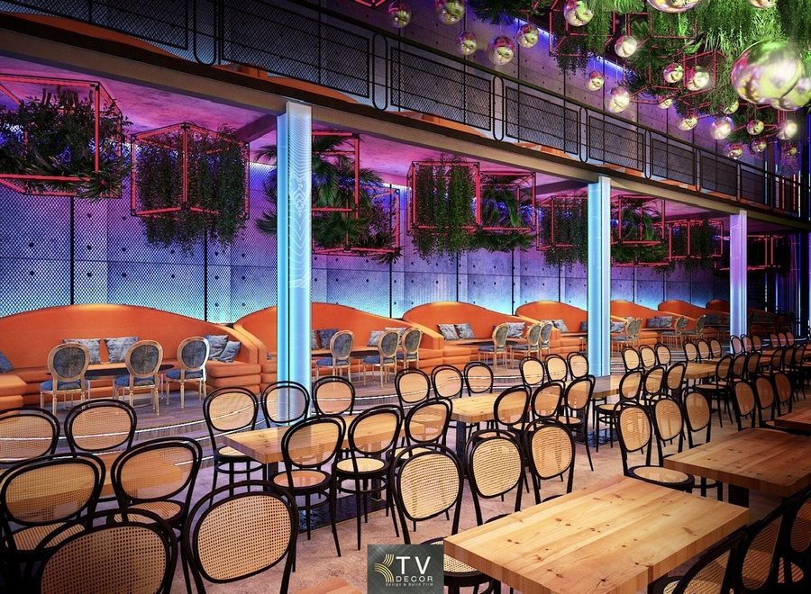 Không gian nội thất Beer Food Garden được thiết kế theo phong cách mở, nổi bật với hệ bàn gỗ dài trung tâm, tạo cảm giác kết nối và sôi động. Trần cao kết hợp đèn trang trí nghệ thuật, ánh sáng đổi màu và cây xanh treo giúp không gian luôn tươi mới, cuốn hút. Bố cục rộng rãi, lối đi thoáng giúp phục vụ số lượng lớn khách cùng lúc, phù hợp tổ chức tiệc, sự kiện và các buổi tụ họp đông người. 